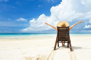 Girl on a tropical beach with hat